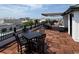 Spacious rooftop deck features wood flooring, black metal railing and an awning, perfect for entertaining at 21 George St # 102, Charleston, SC 29401