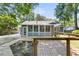 Charming backyard featuring a wooden deck, a screened-in porch, and lush landscaping, perfect for outdoor enjoyment at 211 White Church Ln, Summerville, SC 29485