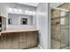 Bathroom with double sinks, granite countertop, wood vanity, and tiled shower at 211 White Church Ln, Summerville, SC 29485