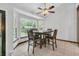 Cozy dining area with a large window, ceiling fan and tile floors at 211 White Church Ln, Summerville, SC 29485