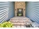 Inviting home entrance featuring brickwork and elegant outdoor lighting at 211 White Church Ln, Summerville, SC 29485