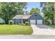 Charming blue home with a well-manicured lawn, two-car garage, and inviting curb appeal at 211 White Church Ln, Summerville, SC 29485
