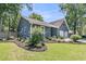 Side view of blue home with well manicured lawn and flower beds at 211 White Church Ln, Summerville, SC 29485