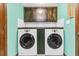 Functional laundry room featuring side-by-side washer and dryer and upper wood cabinets for ample storage at 211 White Church Ln, Summerville, SC 29485