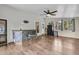 Sunroom features hardwood floors, many windows, a ceiling fan, slate tile bar counter, and black refrigerator at 211 White Church Ln, Summerville, SC 29485