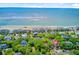 Stunning aerial view of beachfront properties surrounded by lush trees and the tranquil ocean waves at 22 Beachwood East, Isle of Palms, SC 29451