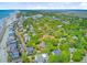 Scenic aerial shot of a neighborhood with tree-lined streets and homes close to the beach and waterfront at 22 Beachwood East, Isle of Palms, SC 29451