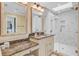 Elegant bathroom with marble countertop, framed mirror, and glass enclosed shower at 22 Beachwood East, Isle of Palms, SC 29451