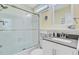 Bright white bathroom with glass shower featuring silver hardware and accessories and large vanity mirror at 22 Beachwood East, Isle of Palms, SC 29451