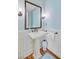 Bright bathroom featuring a pedestal sink with bronze hardware and decorative walls at 22 Beachwood East, Isle of Palms, SC 29451