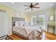 Bright bedroom featuring hardwood floors, ceiling fan, neutral toned walls and access to the deck through french doors at 22 Beachwood East, Isle of Palms, SC 29451