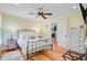 Bedroom with ceiling fan and hardwood floors featuring a queen bed and views of an adjoining room at 22 Beachwood East, Isle of Palms, SC 29451