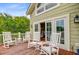Relaxing deck area featuring multiple white rocking chairs and sliding door access to interior at 22 Beachwood East, Isle of Palms, SC 29451