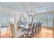 Bright dining room with skylight, shutters, wooden table and seating for twelve at 22 Beachwood East, Isle of Palms, SC 29451