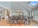 Elegant dining room featuring a long wooden table, seating for many, and a stylish light fixture at 22 Beachwood East, Isle of Palms, SC 29451