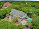 Gorgeous house with a pool in a backyard oasis featuring palm trees, a patio, and well-manicured landscaping at 22 Beachwood East, Isle of Palms, SC 29451
