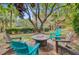 A backyard firepit is surrounded by adirondack chairs, with the home in the background and lush landscaping at 22 Beachwood East, Isle of Palms, SC 29451