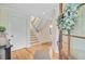 Bright foyer with hardwood floors, white wainscoting, and staircase leading to the second floor at 22 Beachwood East, Isle of Palms, SC 29451