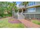 Beautiful front yard with brick pathway leading to the entrance of the house with mature landscaping at 22 Beachwood East, Isle of Palms, SC 29451
