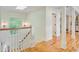 Bright hallway featuring beautiful hardwood floors, wainscoting, and leads to other parts of the home at 22 Beachwood East, Isle of Palms, SC 29451