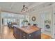 Kitchen island with wood countertop, cabinets, and open view to dining area and laundry room at 22 Beachwood East, Isle of Palms, SC 29451