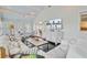 Bright living room with painted floors, large windows and casual decor at 22 Beachwood East, Isle of Palms, SC 29451