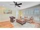 Comfortable living room featuring hardwood floors, wicker chair and sand dollar-themed rug at 22 Beachwood East, Isle of Palms, SC 29451