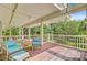 Exterior patio with lovely wooded view featuring comfortable seating beneath overhead lighting at 22 Beachwood East, Isle of Palms, SC 29451