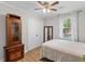 Cozy bedroom features natural light, ceiling fan, wood floors, and closet for storage at 230 Azalea Ct, Moncks Corner, SC 29461