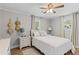Bright bedroom features a ceiling fan, natural light, wood floors, and decor at 230 Azalea Ct, Moncks Corner, SC 29461