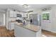 Well-lit kitchen featuring white cabinets, stainless steel appliances, and an island at 230 Azalea Ct, Moncks Corner, SC 29461