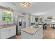 Modern kitchen with stainless steel appliances, island, and adjacent dining area at 230 Azalea Ct, Moncks Corner, SC 29461