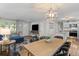Open-concept living area with dining table, TV, and access to the kitchen at 230 Azalea Ct, Moncks Corner, SC 29461