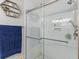 Modern white tiled shower with seamless glass door and modern shower head fixture at 230 Azalea Ct, Moncks Corner, SC 29461