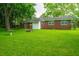 Brick house with a spacious backyard with a fire pit and mature trees at 2567 Mona Ave, Charleston, SC 29414