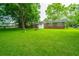 Brick house with a spacious backyard with a fire pit and mature trees at 2567 Mona Ave, Charleston, SC 29414