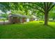 A well-maintained backyard featuring lush grass and mature trees at 2567 Mona Ave, Charleston, SC 29414