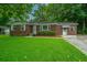 Traditional brick home with a well-maintained lawn and mature trees at 2567 Mona Ave, Charleston, SC 29414