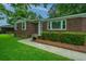 Charming single-story brick home with lush green lawn and neatly trimmed hedges at 2567 Mona Ave, Charleston, SC 29414