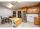 Cozy kitchen with stainless steel fridge, portable kitchen island, and tile floors at 2567 Mona Ave, Charleston, SC 29414