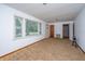 Neutral living room features carpet, a large window, and simple trim at 2567 Mona Ave, Charleston, SC 29414