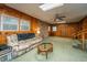 Unique sunken den with wood paneling, stone accent wall, and plush carpeting at 2567 Mona Ave, Charleston, SC 29414