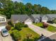 An aerial view of a charming home with a two car garage, lush yard, and a private driveway at 261 Sweet Alyssum Dr, Ladson, SC 29456