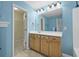 Bathroom with blue walls, vanity and large mirror at 261 Sweet Alyssum Dr, Ladson, SC 29456