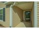 Inviting front porch with neutral siding, well-maintained gutters, and attractive front door at 261 Sweet Alyssum Dr, Ladson, SC 29456
