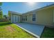 Back patio featuring a vinyl siding exterior, trimmed windows, and green lawn at 261 Sweet Alyssum Dr, Ladson, SC 29456