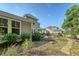 A picturesque backyard with lush landscaping, stone pathway, and charming exterior at 2652 Private Lefler Dr, Johns Island, SC 29455