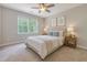 Serene bedroom with a large window, ceiling fan, and a comfortable bed with side tables at 2652 Private Lefler Dr, Johns Island, SC 29455