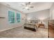 Bright bedroom with large window, ceiling fan, carpeted floor, and closet space at 2652 Private Lefler Dr, Johns Island, SC 29455