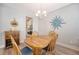 Elegant dining area with wooden table set, decorative wall art, and view into an adjacent kitchen at 2652 Private Lefler Dr, Johns Island, SC 29455